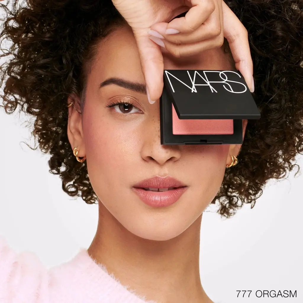 NARS_SU24_Blush_PDPCrop_Modelholdingproduct_Orgasm_GLBL (1).webp